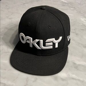 OAKLEY New Era flat brim hat. Black. Raised letters. SnapBack